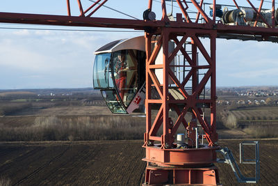 The crane operator high above the ground